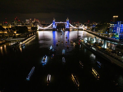 The narrow boats pass HMS Belfast